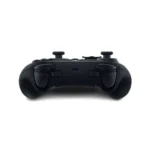 Bottom view of a black game controller with left and right grips visible on a white surface