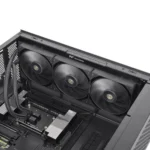 Inside a black computer case with a top-mounted triple‑fan radiator cooling unit, showing the motherboard and pcie slots nearby.