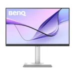 Benq computer monitor on a silver stand, displaying a purple-blue abstract wallpaper.