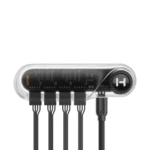 Five-port usb hub with a clear plastic shell, showing internal circuitry and five black cables plugged into each port, connected by a main cable on the right.
