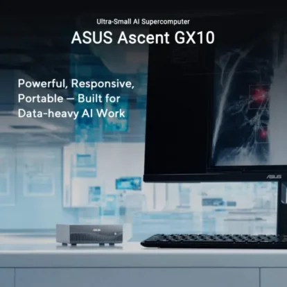 Asus ascent gx10 ultra-small ai supercomputer on a desk beside a monitor and keyboard.