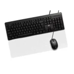 Overhead view of a black wired keyboard with a corded mouse on a translucent white keyboard tray/pad.