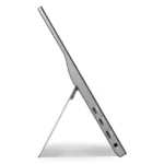 Thin silver tablet in side view propped by a built-in stand, displaying multiple side ports.