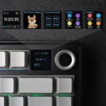 Top view of a mechanical keyboard with an oled status display showing time, date, and tiny icons above the keys.