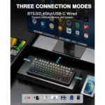 Promotional image showing a backlit keyboard with three connection modes (bt5. 0, 2. 4ghz, usb-c wired) on a desk near a large monitor and a smartphone in a dock.