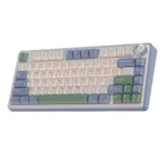 Compact pastel-colored keyboard with pink, blue, and green keycaps and a round trackball on the top-right.