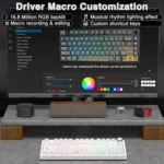 Monitor shows driver macro customization ui with rgb backlight, macro recording/editing, lighting effects, and shortcut keys; desk setup with a backlit keyboard nearby.