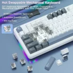Close-up of a hot-swappable mechanical keyboard with switches removed, rgb glow, and a key puller, highlighting features like 60m keystrokes.