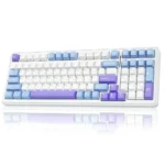 Colorful mechanical keyboard with white body and blue/purple keycaps, shown at an angle with a mirrored surface reflection.