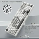 White mechanical keyboard showing hot-swappable pcb sockets and pre-lubed switches, angled view with circular detail inset.