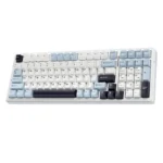 White mechanical keyboard with light blue and gray keycaps, showing full qwerty layout and numeric keypad.