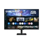 Samsung smart monitor m5 on a black stand displaying its home screen with app icons and a banner ad.