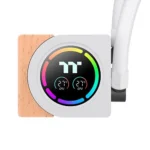Close-up of a thermaltake cpu liquid cooler block with rgb ring and dual temperature readouts (27°c) and white tubing attached to the side